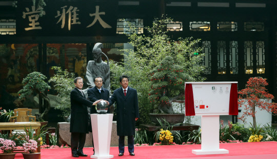 문재인 대통령과 아베(오른쪽) 일본 총리, 리커창(가운데) 중국 총리가 24일(현지시간) 중국 쓰촨성 청두 두보초당에서 한중일 협력 20주년 기념 제막식을 하고 있다. 두보초당은 당나라 시인 두보가 머무른 곳이다.    연합뉴스